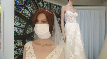 A mannequin wears a face mask in the window display of wedding shop Compagne in Hardenberg. July 3, 2020