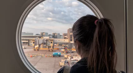A woman waiting at a gate inside Schiphol Airport in Amsterdam. 