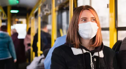 Woman wearing a mask on public transport