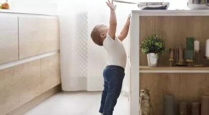 Baby reaching for a pan