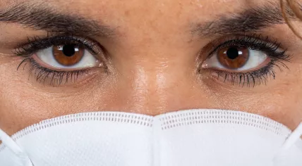 A feverish woman in the Netherlands wearing a face mask