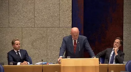 Justice Minister Ferdinand Grapperhaus speaking in parliament with Health Minister Hugo de Jonge and Prime Minister Mark Rutte sitting behind him, 2 September 2020