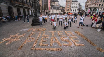 #NoFiltersPlease spelled out in littered cigarette butts on Dam Square in Amsterdam