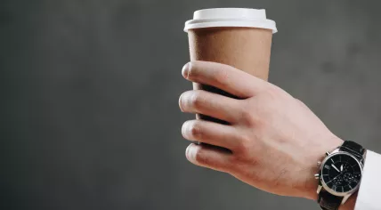 Hand handing out coffee
