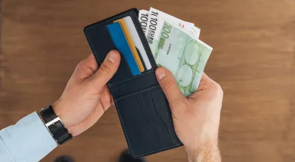 Man taking Euro banknotes from wallet.