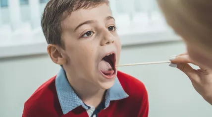 Child getting a throat swab to test for Covid-19