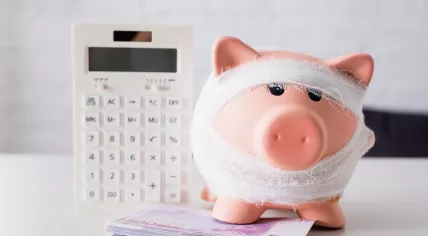 Selective focus of piggy bank near euro banknotes