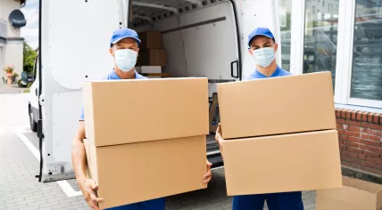Package deliverers wearing face masks