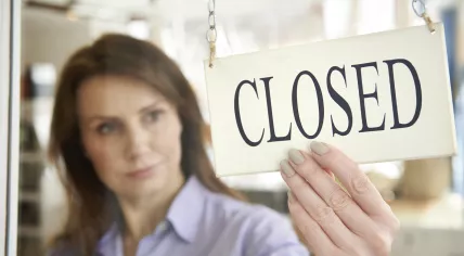 Woman turning open sign