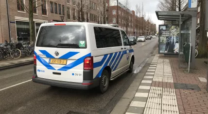 A crew from the Amsterdam public transportation firm GVB inspects swastikas spray painted on an advert featuring Mark Rutte. 12 March 2021
