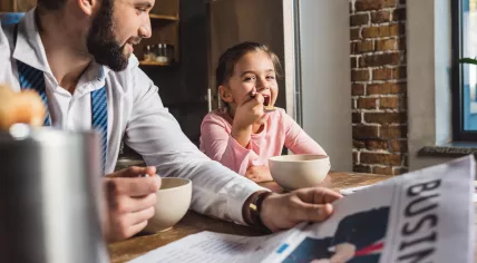 Father and child eating breakfast