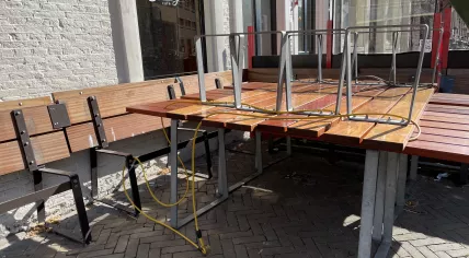 Tables and benches piled up outside of Cafe Fonteyn in Amsterdam's Nieuwmarkt. 19 March 2021