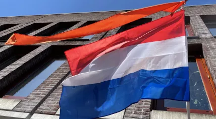 The Dutch flag capped by an orange ribbon flies above a home in Amsterdam on King’s Day.  27 April 2021