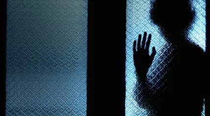 A silhouette of a scared boy.