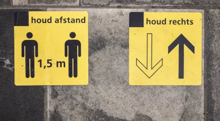 Signs placed on the pavement to remind people of social distancing rules at the Almelo train station. 28 July 2020