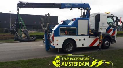 Dutch police towing away a car after an illegal street race in Amsterdam.