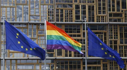 European union flag and LGBT pride flag wave outside of the European Council building in Brussels, Belgium. May 17, 2019.