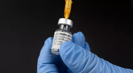 Preparing a syringe with the Comirnaty Covid-19 vaccine from Pfizer/BioNTech. June 2021