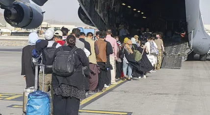 Evacuees boarding a plane at Hamid Karzai International Airport in Kabul, Afghanistan, 18 August 2021