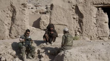 A Dutch soldier speaking to a man in the Uruzgan province of Afghanistan with the help of an interpreter, June 2010