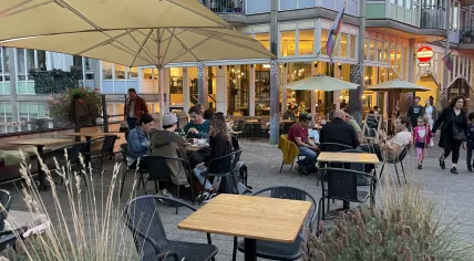 Customers outside Cafe Tisfris in Amsterdam just before closing time. Sept. 25, 2021