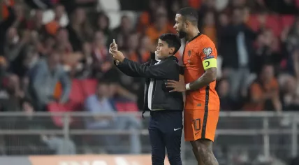 A young fan ran onto the pitch to take a selfie with Memphis Depay of the Netherlands during the World Cup 2022 group G qualifying football match between the Netherlands and Montenegro at the Philips stadium in Eindhoven, 4 September 2021