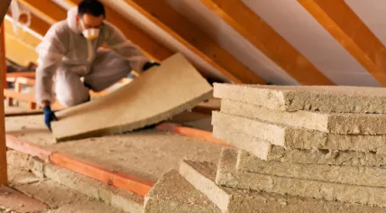 Man laying thermal insulation