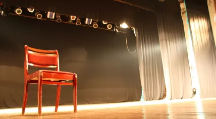 Chair on an empty theater stage