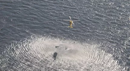 Coast Guard helicopter rescuing a woman from the North Sea, 11 km off the coast of Scheveningen, 8 September 2021