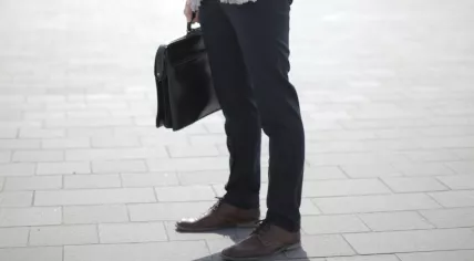 Undated photo of a man holding a briefcase 