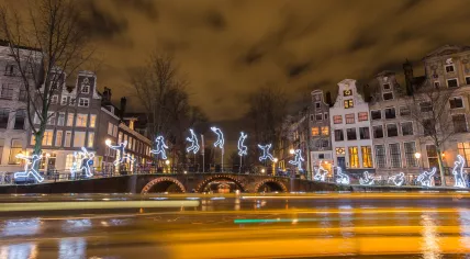 Tour boats view an artwork 'Run Beyond' in a canal on the 'Water Colors' exhibition of the Amsterdam Light Festival, December 2015