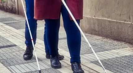 Photo of a visually impaired couple walking