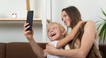Mother taking selfie together with son