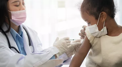 Child receiving shot from pediatrician
