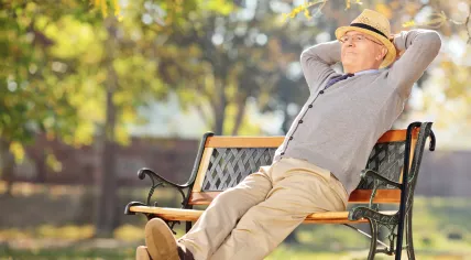 A pensioner enjoying a sunny day in the park