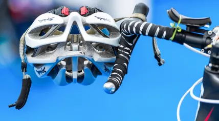 Closeup of helmet and triathlon bike gear in the transition zone
