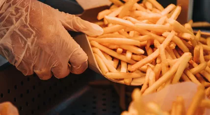 Person prepares french fries