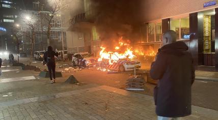 A police car ablaze during a riot against the 2G coronavirus access pass on Coolsingel in Rotterdam. 19 November 2021