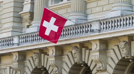 Bundeshaus in Bern with Swiss flag