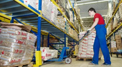 Warehouse worker with a forklift stacker