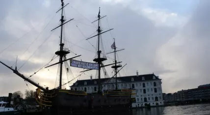 "Zwarte Piet is Racism" banner hung on the replica of VOC ship Amsterdam by Extinction Rebellion, 2 December 2021