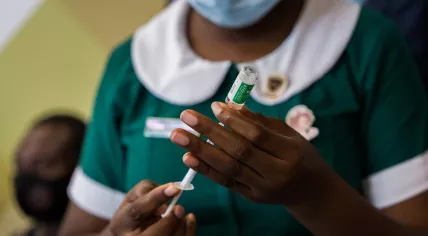 COVAX rollout: COVID-19 vaccinations begin in Ghana - nurse prepares to administer a dose