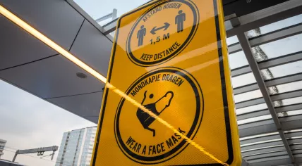 Reminders about social distancing and face mask use at a public transportation stop in Nieuwegein. July 2020
