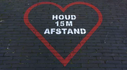 A social distancing reminder painted on the Slijkstraat in Weesp. June 2021