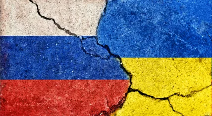 Cracked flags of Ukraine and Russia
