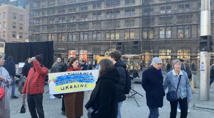 Julija Smitaite holds a sign reading "Lithuania stands with Ukraine" at a protest against the Russian invasion of Ukraine on Feb. 27, 2022.