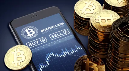 Rendering of a smartphone showing a Bitcoin Cash trading chart next to stacks of Bitcoin Cash coins