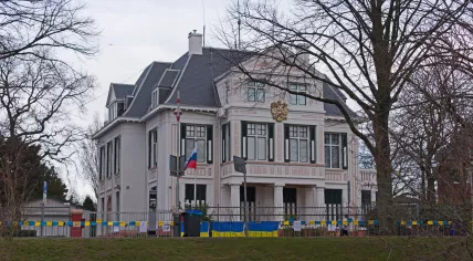 Ukrainian flags adorn the fence outside the Russian Embassy in The Hague. 12 March 2022