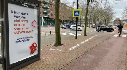 A bus stop featuring a VVD poster was vandalized with anarchy symbols, Amsterdam Oost, 16 March 2022