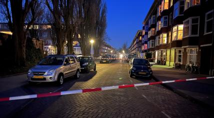 Crime scene tape where a 21-year-old man was shot dead on Hunzestraat in Amsterdam, 23 March 2022